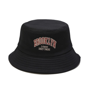 Black canvas bucket hat with red Brooklyn 1898 embroidery on a white background