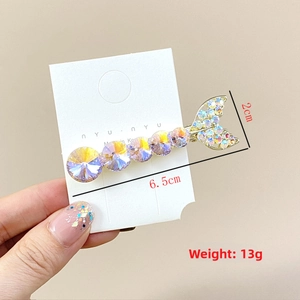 Detail of mermaid tail hair clip with purple K9 crystals and rhinestones on gold base
