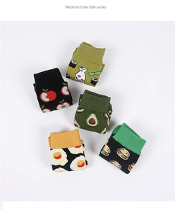 Flat lay of five cotton socks featuring apple, sushi, avocado, egg, and burger patterns