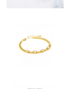 Detail of titanium gold bracelet featuring five zircon-encrusted heart pendants with Cuban chain