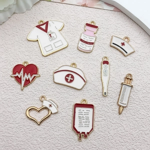 Detail showing colorful enamel medical charms including nursing cap, syringe and thermometer