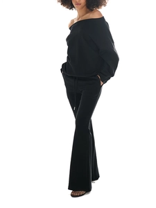 Detail of off-shoulder black sweatshirt and flared sweatpants two-piece casual set
