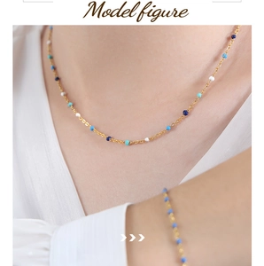 Detail view of colorful oil-dripped enamel beads on golden titanium chain set