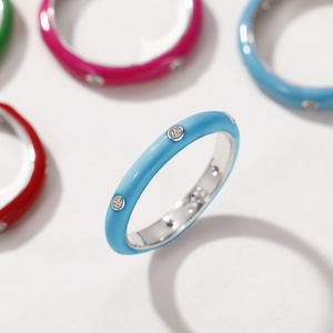 Detail shot of a minimalist colorful enamel ring with inlaid sparkling zircon stones