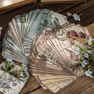 Vintage floral junk journal paper with birds and butterflies on wood background