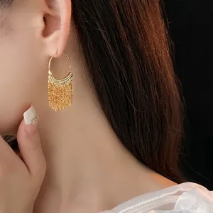 Elegant gold C-shaped fringe drop earrings for women with long metallic tassels