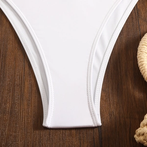 Close-up of double stitching and knit texture on white lace bikini bottom