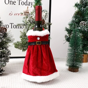 Détail d'une robe de fête pour bouteille de vin en velours rouge avec bordure en peluche