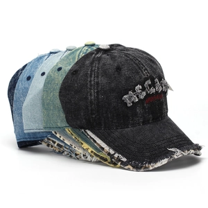 Detail showing distressed denim baseball caps with frayed edges and 3D embroidery