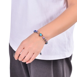 Bohemian 8mm emperor stone beaded bracelet with a blue heart pendant on a female wrist