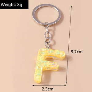 Letter F keychain in yellow resin with iridescent sequins measuring 9.7 cm in total length