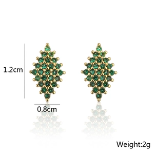 Detail view of gold-plated rhombus earrings with green zircons and size specifications