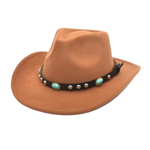 Detail of brown wool cowboy hat with leather band featuring turquoise and gold metal studs