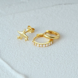 Macro shot of 925 silver gold-plated star studs and zircon hoops with S925 hallmark