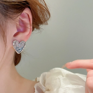 Vintage silver heart stud earrings with crushed ice texture on model for women