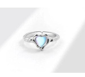 Macro shot of irregular silver ring with heart-shaped light blue moonstone detail
