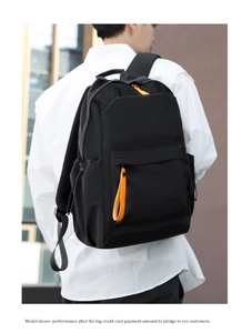 Detail of waterproof Oxford backpack showing thickened straps and orange zip accents