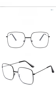 Close-up of lightweight black square metal eyeglass frames with minimalist temples