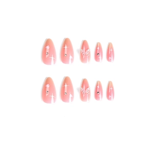 Pink gradient almond press-on nails with white stars, rhinestones and butterfly charms