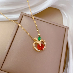 Luxury gold apple pendant necklace with red gem and sparkling white crystals for women