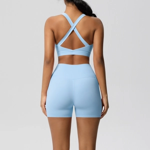 Light blue yoga set featuring a cross-back sports bra and high-waisted shorts back view