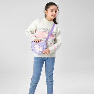 Detail of soft purple plush unicorn crossbody bag with embroidery on young girl model