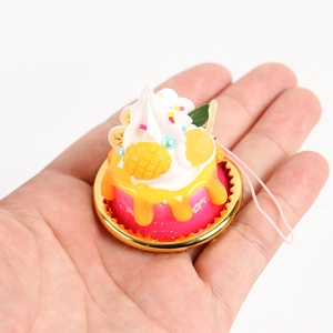 Realistic pink cream cake model with fruit toppings and pink strap for store display