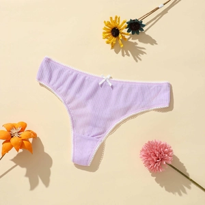 Detail of light purple ribbed thong with white lace trim and delicate bow accent