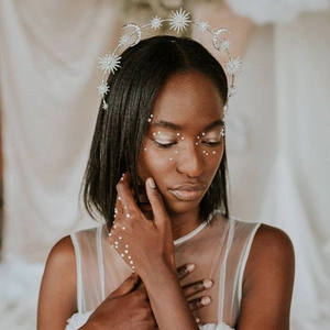 Detailed view of silver star and moon crown headpiece with sparkling crystal inlay