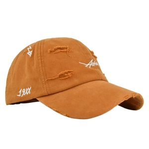 Detailed close-up of vintage distressed baseball cap with embroidery and frayed edges