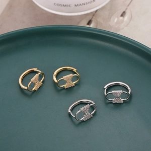 French retro gold and silver hoop earrings with micro-paved zircons on a ceramic tray