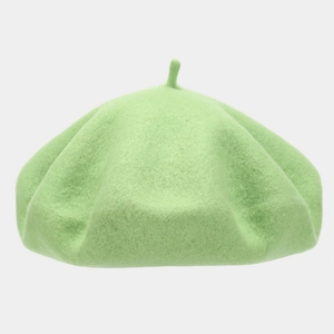 Detail shot of a mint green wool beret hat featuring a soft felt texture and top stem