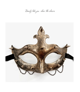 Macro detail of bronze steampunk half face mask with metal spikes and hanging chains