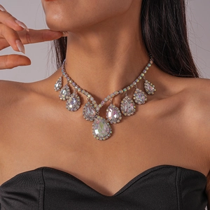 Detailed view of silver choker necklace with iridescent teardrop crystals on neck