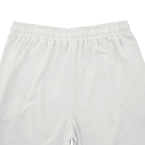 Detail of the elastic waistband on white cotton casual pants with drawstring
