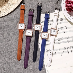 Detail view of five square leather watches in brown, blue, purple, white and black colors