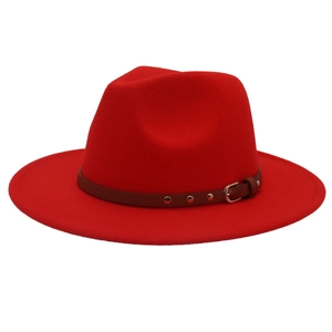 Macro detail of red wool fedora with studded brown leather band and silver buckle