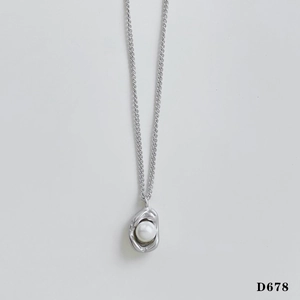 Detailed close-up of a silver necklace featuring an irregular metal pearl pendant