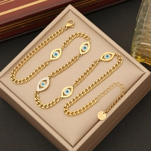 Close-up of golden evil eye jewelry set with blue crystals in a soft jewelry box