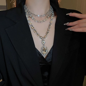 Elegant multi-layer necklace with pear-shaped crystal pendant and silver-toned finish
