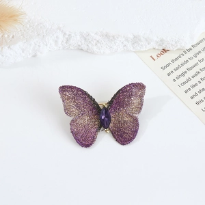 Detail of purple embroidery butterfly brooch with gemstone and fresh water pearls