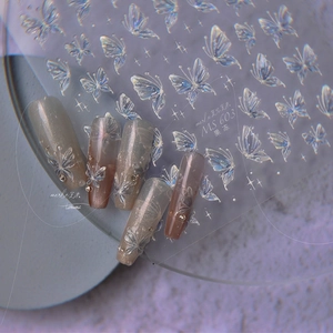 Macro shot of iridescent aurora butterfly nail stickers and aurora-themed press-on nails