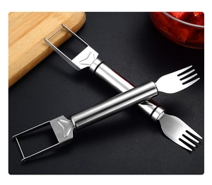 Dual-head stainless steel watermelon cutter and fork tool on a textured countertop