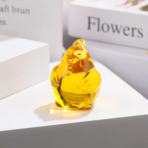 Macro shot of an amber translucent glass rooster figurine for desktop decoration