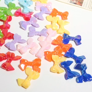 Colorful UV-plated resin bow beads scattered for DIY jewelry and accessory making