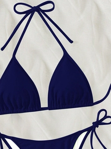 Close-up of dark blue bikini set featuring honeycomb texture and adjustable tie strings