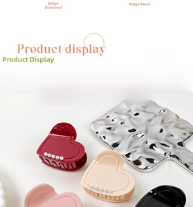 Detail showing acetate heart claw clips with pearl borders in various colors