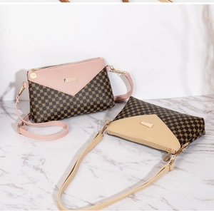 Detail of stylish square shoulder bags in pink and beige with circle patterns