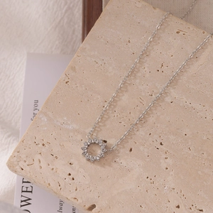 Minimalist silver sun flower zircon necklace with round pavé pendant on stone