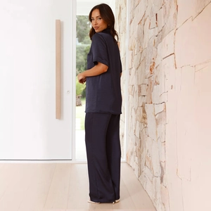 Close-up of dark blue satin loungewear set featuring a silky texture and elegant drape